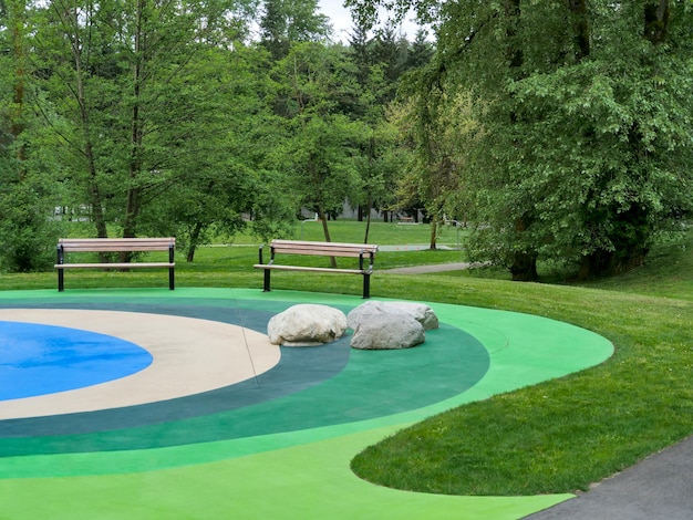 Aire de loisirs dans un parc avec deux bancs sur sol coloré