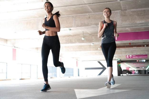 Ajustez les femmes en vêtements de sport en faisant du jogging à l'extérieur et en menant un mode de vie sain.