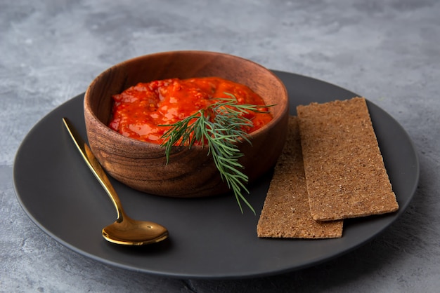 Photo ajvar, lutenitsa, pinjur, harissa avec du pain sur une plaque