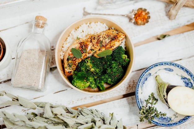 aliment riche en protéines avec du riz au poulet brocholi et aubergine dans une boîte écologique livrée