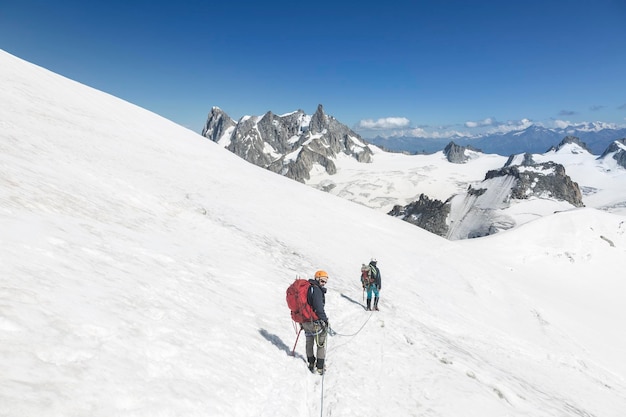 Alpinistes avec corde et outils d'escalade sur le Col du Midi en face du massif des Grandes Jorasses Mont Blanc dans les Alpes françaises Chamonix MontBlanc France