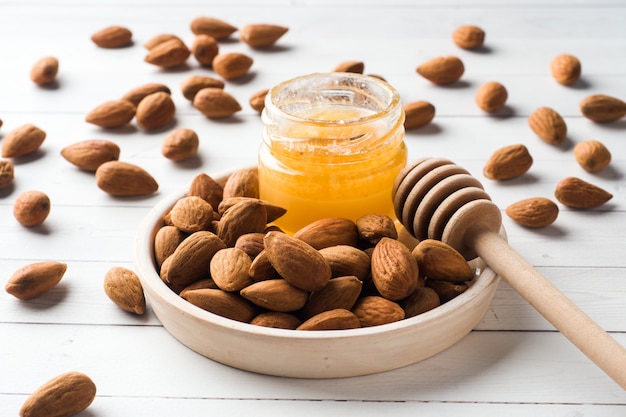 Amandes et une boîte de miel sur la table.