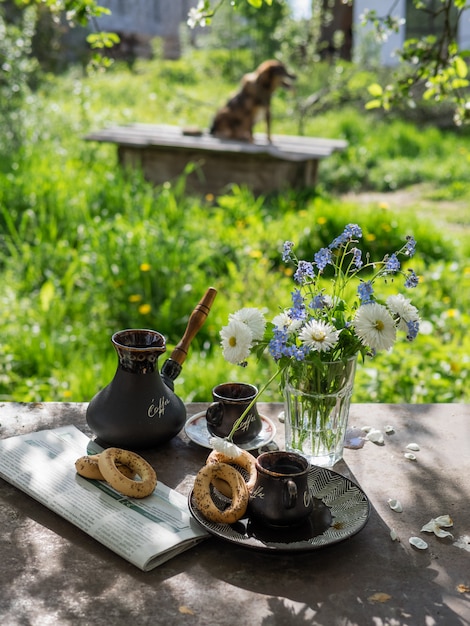 Ambiance d&#39;été. Petit déjeuner dans la rue avec café et fleurs