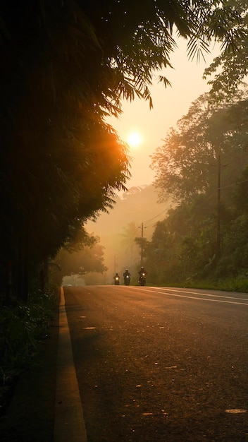 Photo ambiance de rue publique le matin avec brouillard et lever de soleil