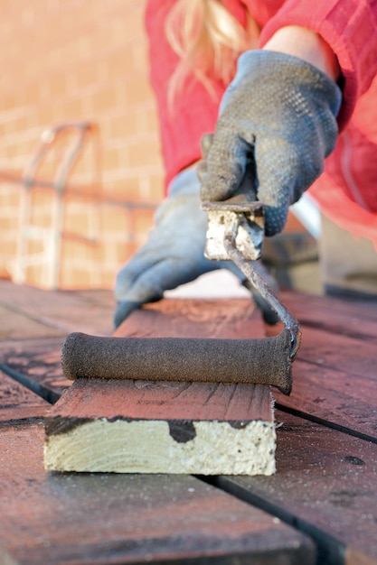 Amélioration de l'habitat bricoleuse peinture planche de bois à l'extérieur