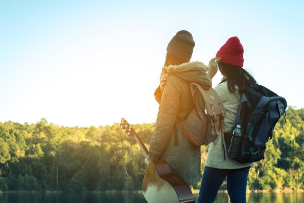 Photo des amies debout au bord de la rivière