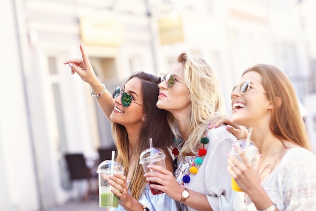 amies heureuses traînant dans la ville en été