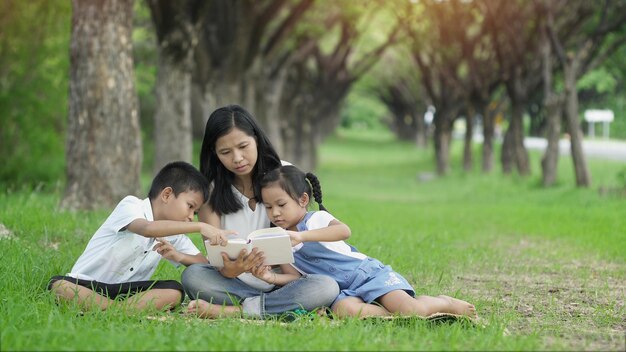 Des amis assis sur l'herbe contre les plantes