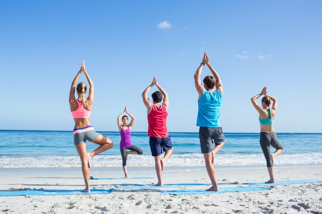 Amis faisant du yoga avec leur professeur