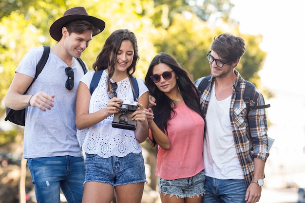 amis de la hanche regardant appareil photo numérique en plein air