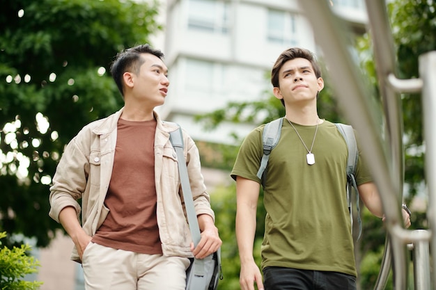 Amis marchant sur le campus universitaire