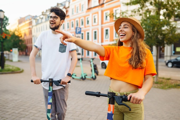 Des amis sur des scooters électriques pour se détendre ensemble en plein air dans la ville Style de vie actif