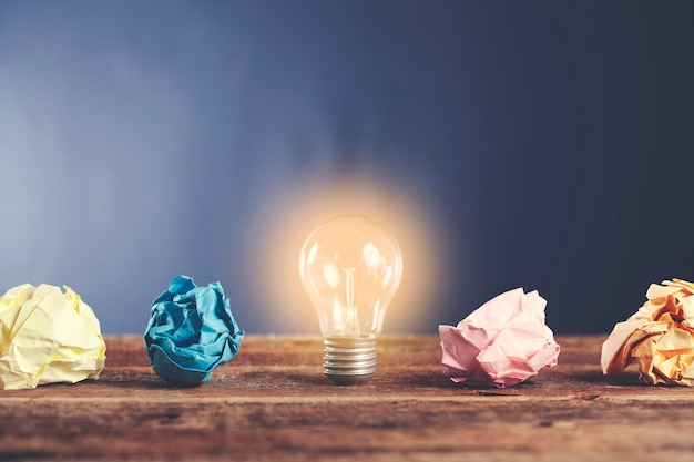 Ampoule avec papier froissé sur un bureau en boisxDxA