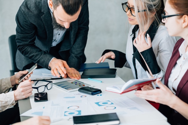 L'analyse des données. Discussion de travail d'équipe d'affaires. Chef d'équipe regardant des diagrammes dans une tablette.