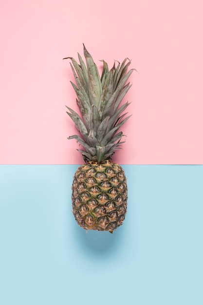 Ananas entier sur fond rose et bleu