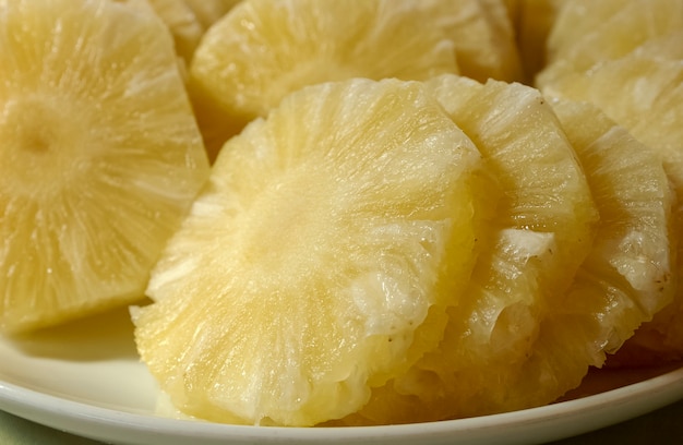 Ananas. Jus et fruits coupés sur la table.