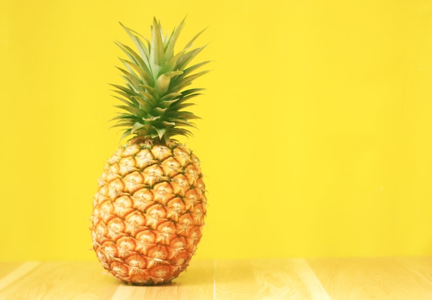 Ananas mûr sur un fond en bois jaune