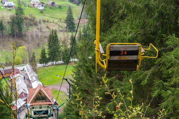 Ancien téléski Arbres et montagnes en arrière-plan Forfait de ski abandonné Siège de remontée jaune avec le numéro 24