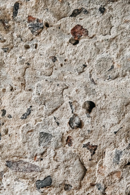 Ancienne surface en béton gris avec des fissures et des pierres comme texture de fond. Copie, espace vide pour le texte