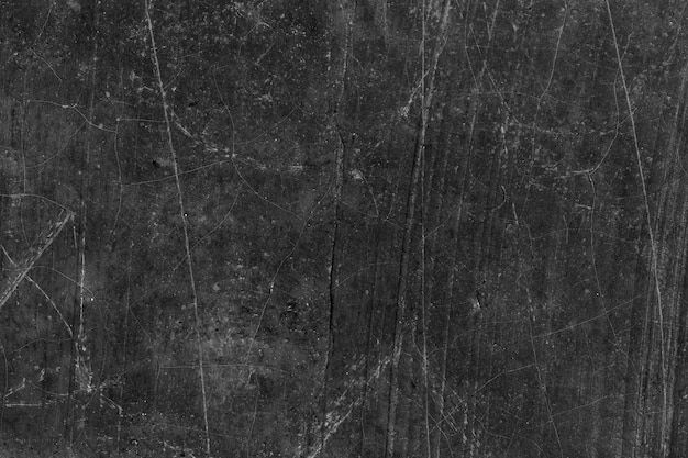 Ancienne surface de mur en béton gris foncé abandonnée avec des rayures et des fissures pour le fond de texture