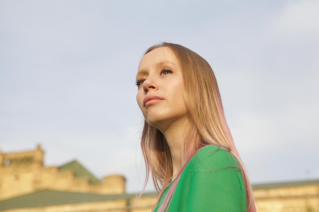 Angle bas gros plan d'une magnifique jeune femme regardant le coucher du soleil