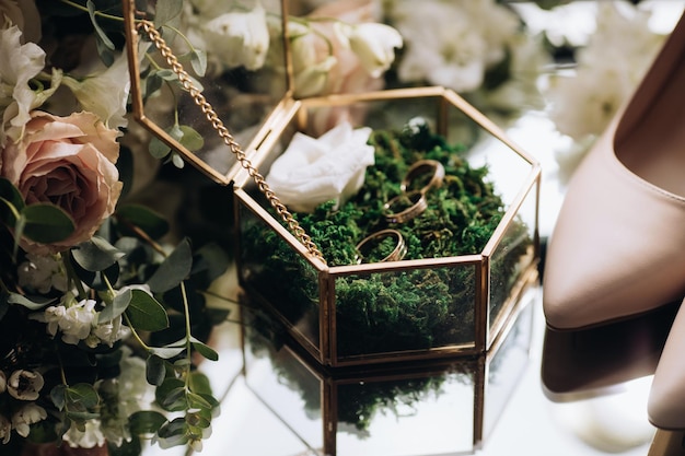 Anneaux de mariage dorés pour les mariées sur la mousse verte