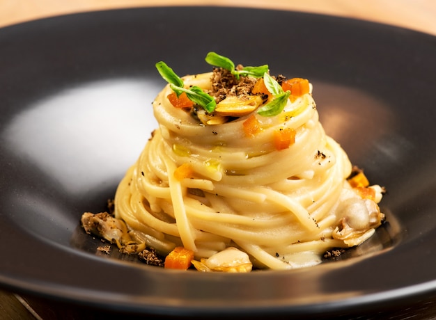 Apéritif gastronomique avec linguine, palourdes et truffes