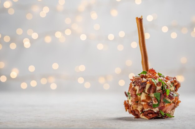 Photo des apéritifs de fromage de noël avec du bacon, des noix de pécan et des herbes