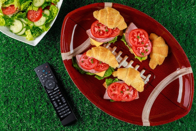 Apéritifs sur la plaque avec télécommande tv pour la fête du football.