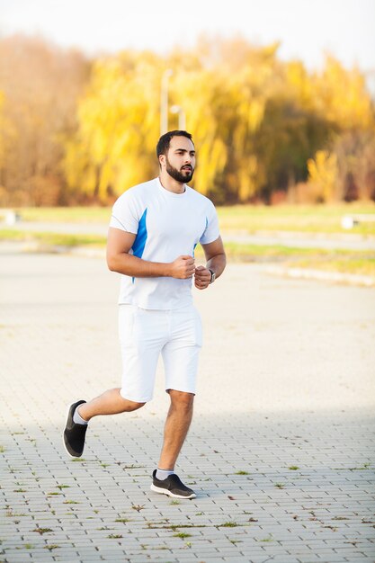 Aptitude. Homme coureur épuisé au repos sur le parc après l'entraînement