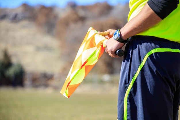 Arbitre assistant de football tenant un drapeau