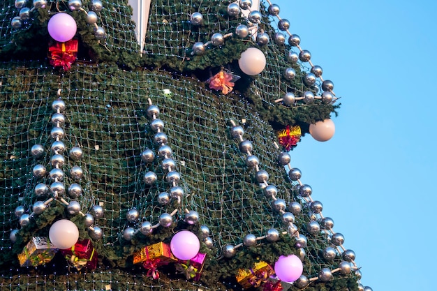 Arbre de Noël décoré sur fond de ciel bleu. partie de grand arbre de Noël en plein air libre