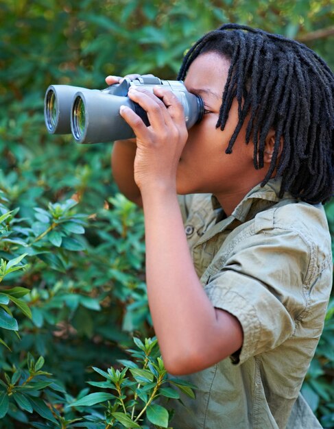 Arbres de la nature binoculaire et noir enfant regarder vue sur la nature sauvage sur l'aventure exploration en plein air ou voyage de camping randonnée forestière durable et recherche d'enfant pour la destination dans les bois écologiques