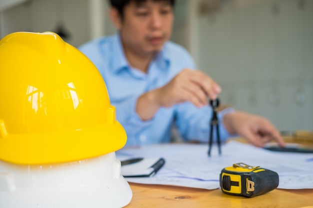 Architecte ou planificateur travaillant sur des dessins pour les plans de construction à une table