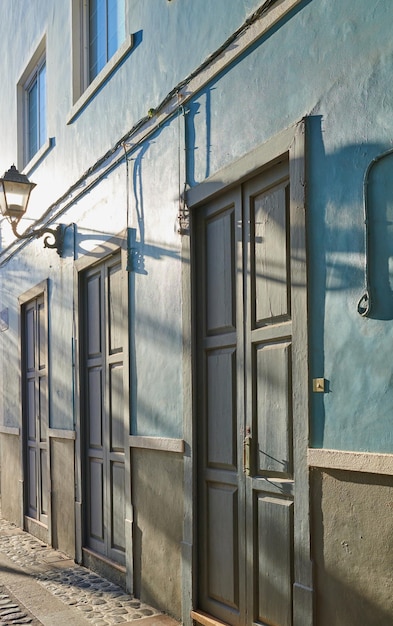 Architecture classique de bâtiments dynamiques aux portes bleues dans une ville Vue rapprochée de maisons ou de maisons anciennes et traditionnelles dans une petite ville ou un village vintage aux couleurs vives et au design unique