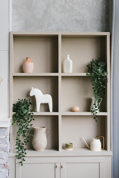 Armoire ouverte avec étagères décorées de vases et de plantes d'intérieur de style scandinave