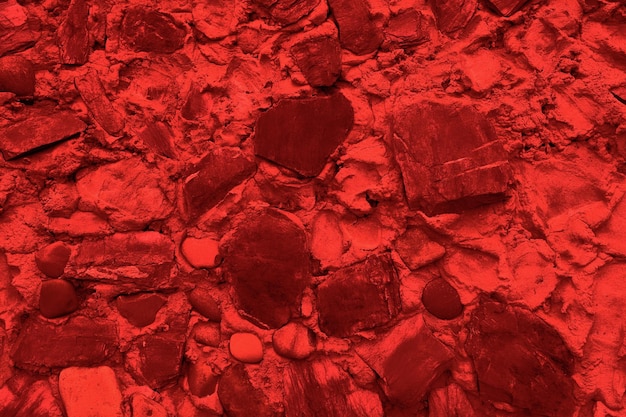 Arrière-plan abstrait de nombreuses grosses pierres La surface de la pierre vide est rouge