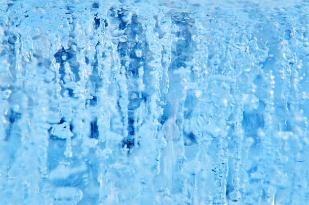 Arrière-plan bleu flou - jet de glace ou d'eau avec des bulles