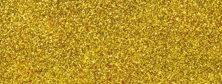 Photo arrière-plan brillant et doré abstrait à partir de petites paillettes macro arrière-plan jaune étincelant avec un gros plan de motif de grain