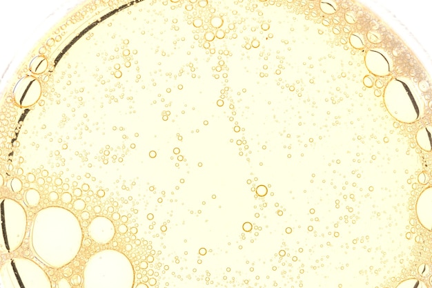 Arrière-plan de bulles d'huile jaunes abstraites Produit de beauté liquide cosmétique