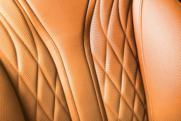 Arrière-plan en cuir perforé pour la conception orange été couleur de texture cuir artificiel avec couture