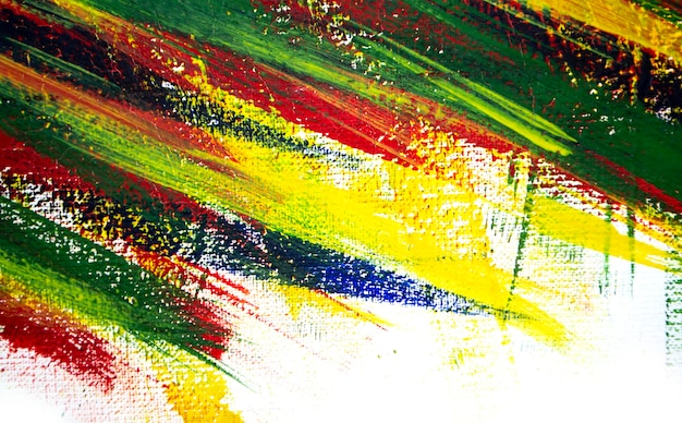 Photo arrière-plan de différents traits de peinture rouge, jaune, verte et bleue avec pinceau sur gros plan de fond blanc. toile de fond colorée et lumineuse de lignes de brosse. v rayures colorées de peinture sur toile blanche
