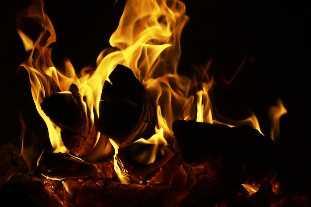 Arrière-plan de la flamme dans le four Langues de feu dans une cheminée en briques Texture feu
