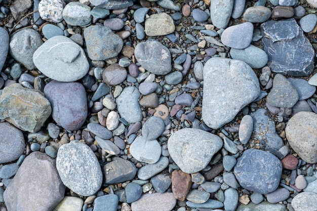 Arrière-plan de petits cailloux et pierres au bord de la mer ou dans le jardin