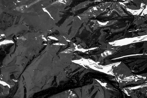 Arrière-plan à texture recouverte d'un film plastique transparent noir