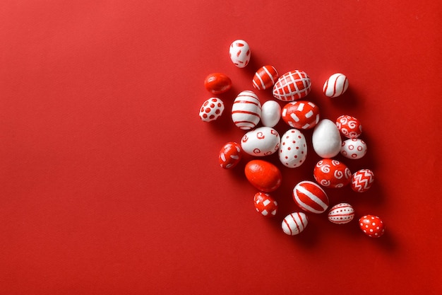 Photo arrière-plans de pâques oeufs de pâques rouges et blancs dispersés sur un fond rouge vif