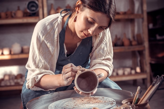 Artisan élégant fabriquant un sculpteur de poterie à partir d'argile humide sur roue Fabrication artisanale