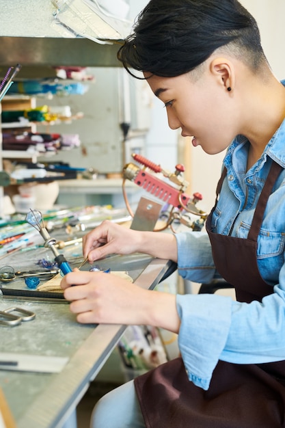 Artiste asiatique au travail de la lampe en studio