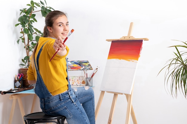 Artiste féminine peinture en atelier fond blanc