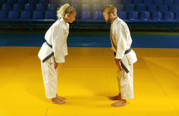 Arts martiaux. épargner les porteurs. Sport homme et femme se saluent avant un combat dans la salle de sport